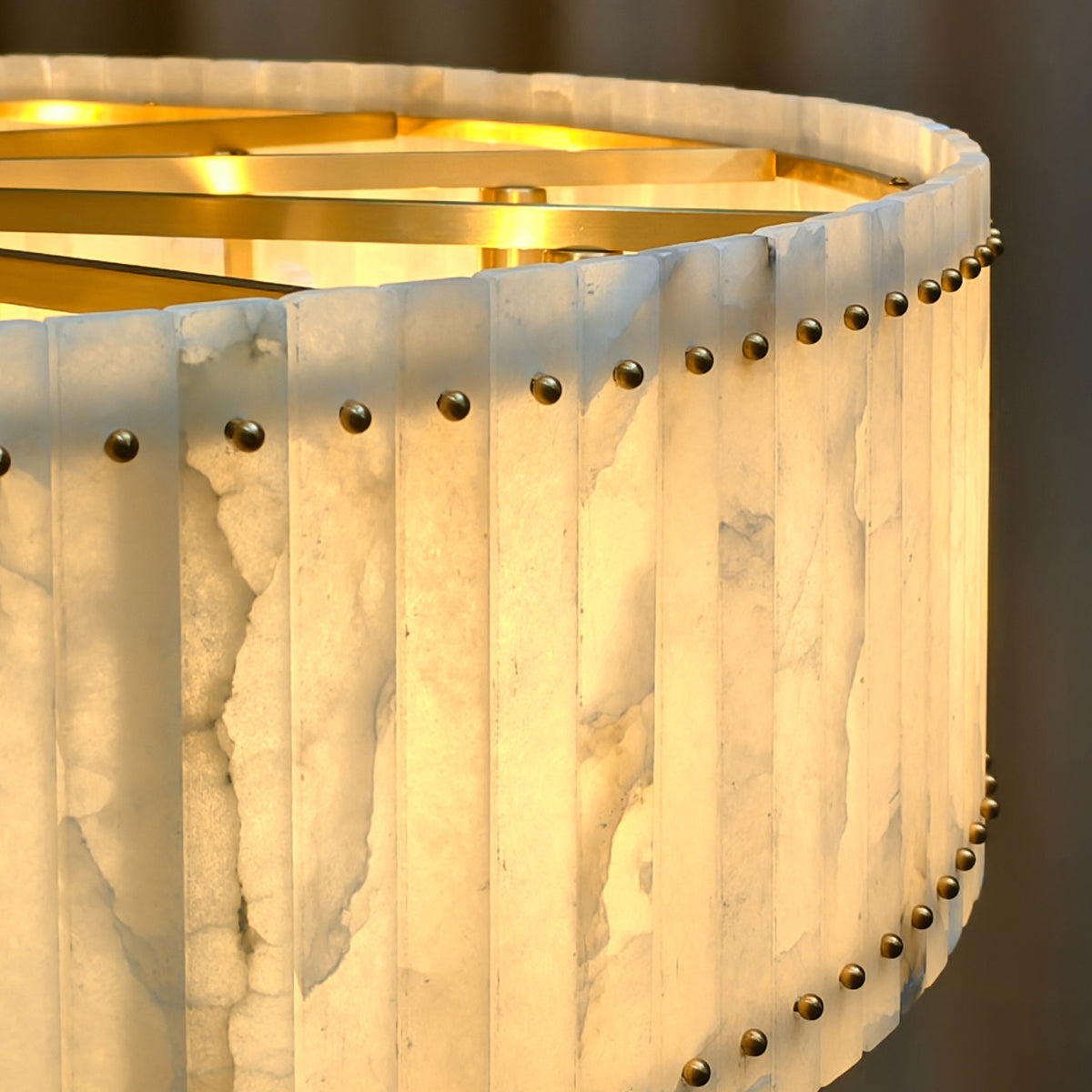 Illuminated alabaster panels and gold-tone fasteners, close-up detail
