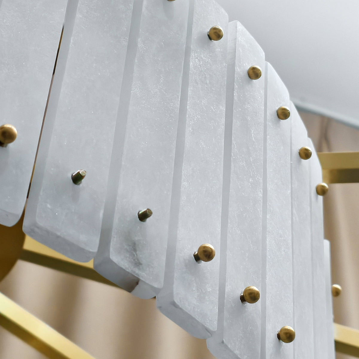 Unlit alabaster panels and gold-tone fasteners, close-up detail