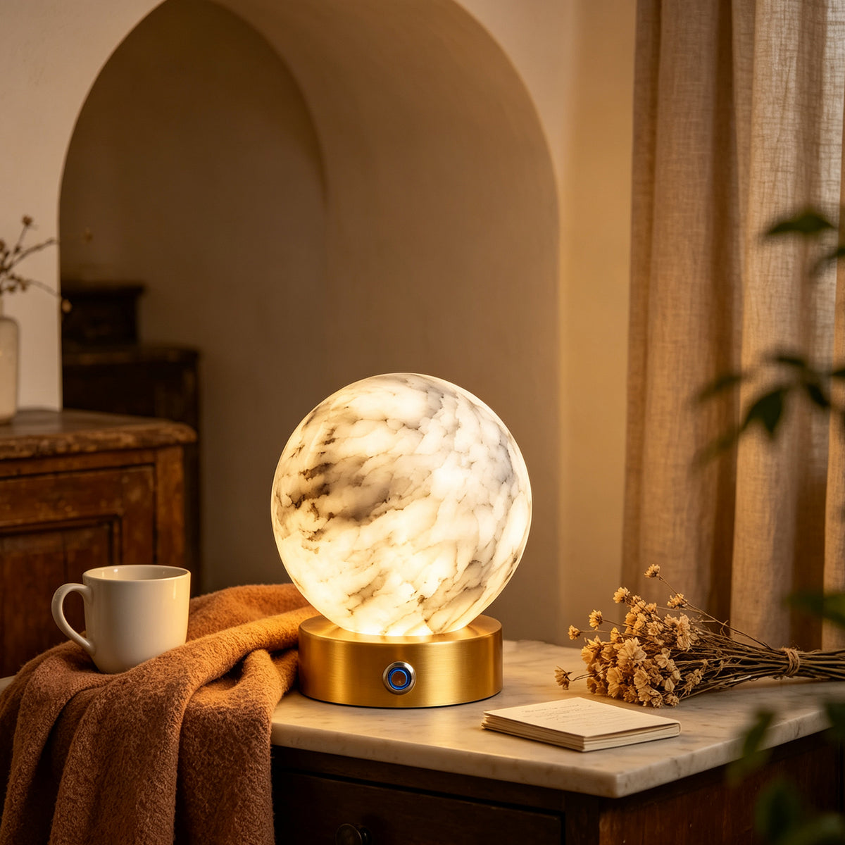 Rechargeable alabaster globe lamp styled on a side table