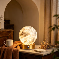 Rechargeable alabaster globe lamp styled on a side table