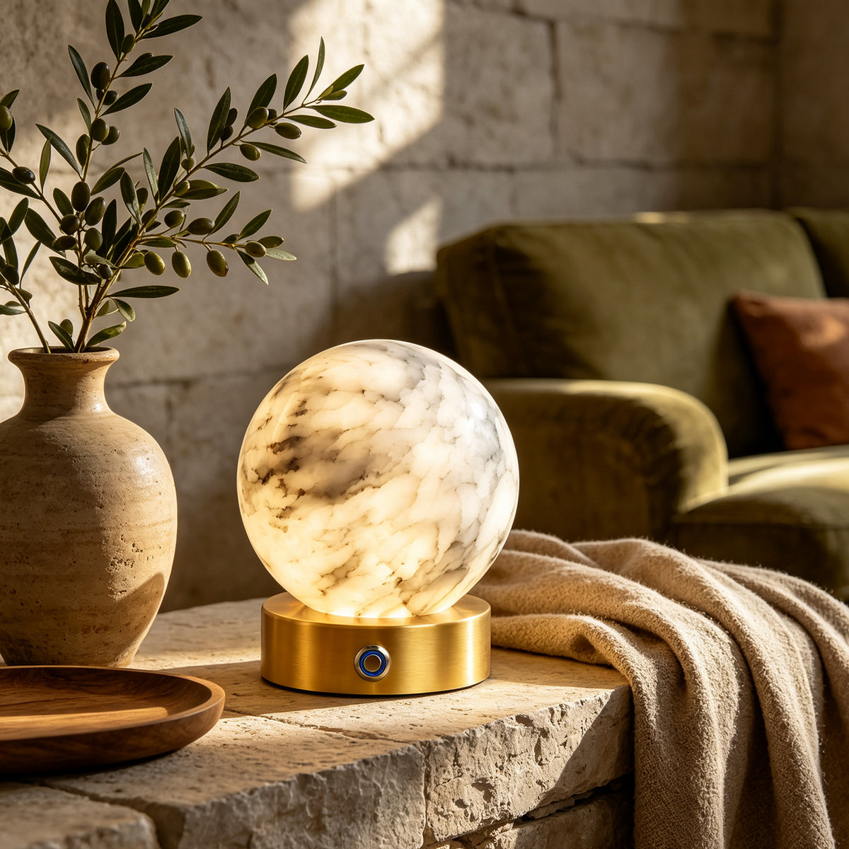 Alabaster globe table lamp on a stone side table in a living room