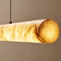 Close-up of the cylindrical alabaster pendant shade showing amber-toned veining when illuminated