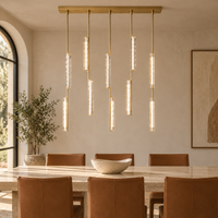 Audubor Brass chandelier above a travertine dining table