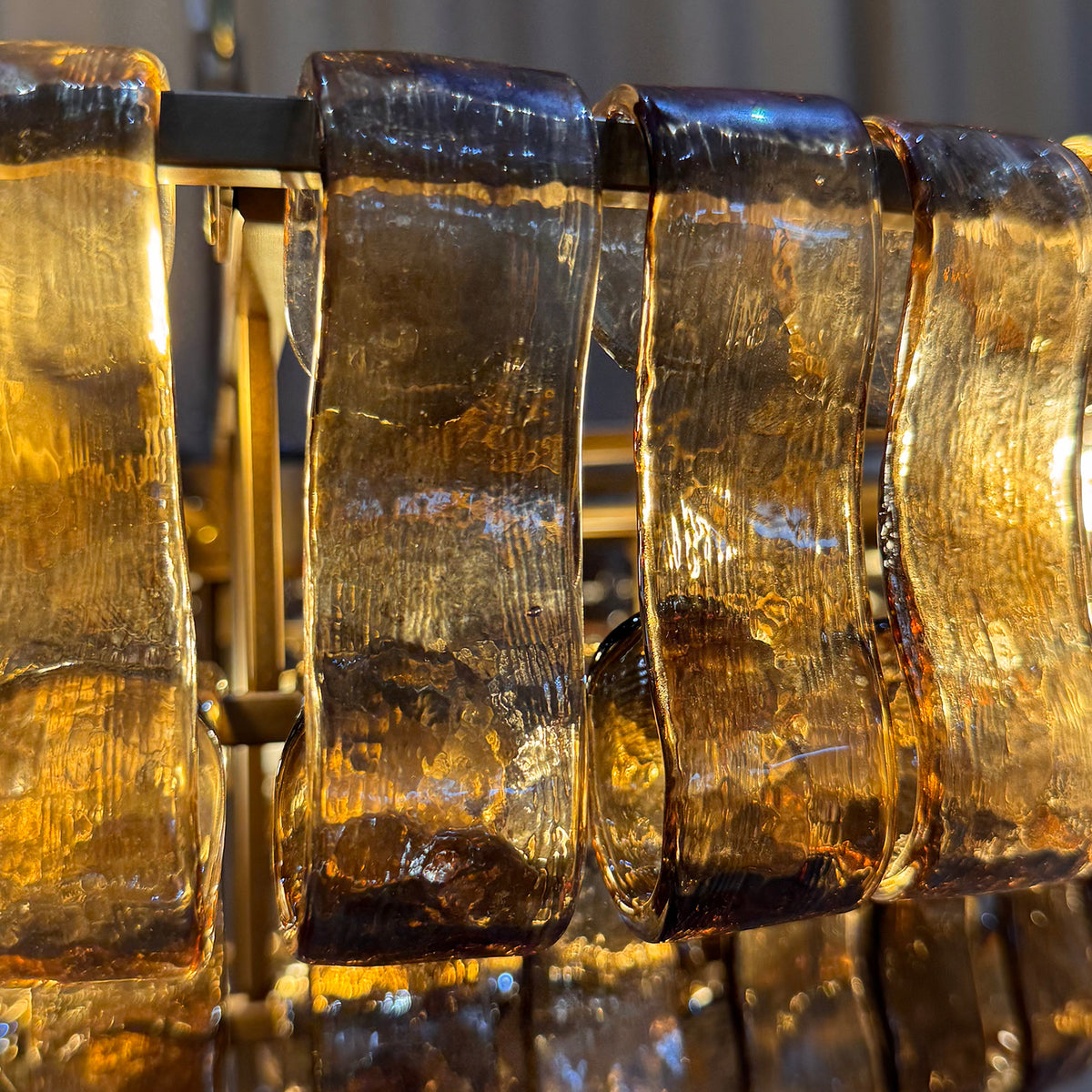 Light shining through the curved glass chandelier panels