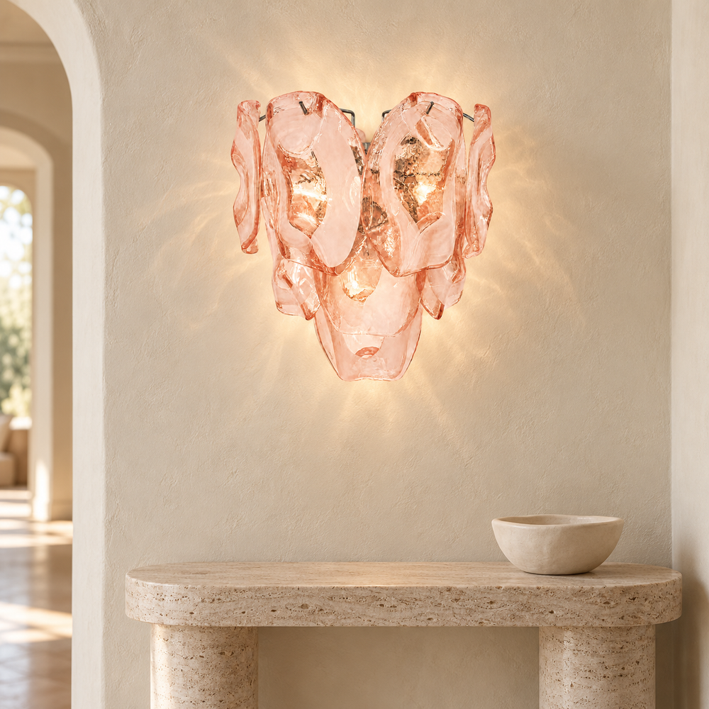 Lucent Petal pink glass wall sconce in a pale travertine entryway