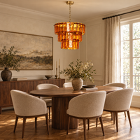 Solenne Ember amber glass chandelier above a walnut dining table